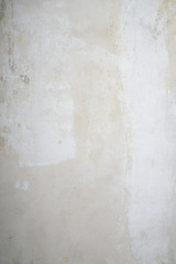 bare interior wall after wallpaper was removed, shabby grunge vertical background texture