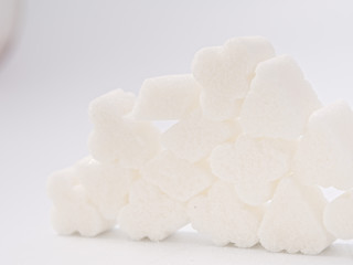 white lump sugar refined on a white background.