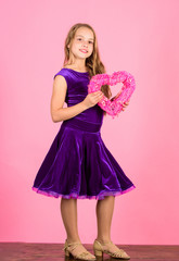 Girl cute child show heart shaped decor. Symbol of love. Kid adorable girl with long hair happy face show heart to you. Look in heart part. Celebrate valentines day. Love holiday decor. Love concept