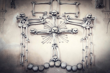 Skulls and bones covered in dust. lot of creepy human remains in dark. Abstract dark background symbolizing death, evil