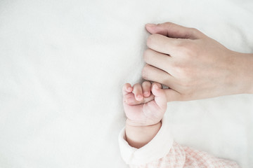 New Born Baby hand hold finger of mom: concept of love, take care, parent relationship