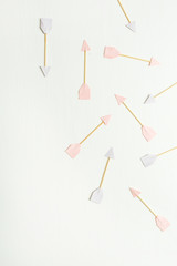 Paper Cupid arrow symbols on white background. Flat lay, top view Valentines Day background love concept.