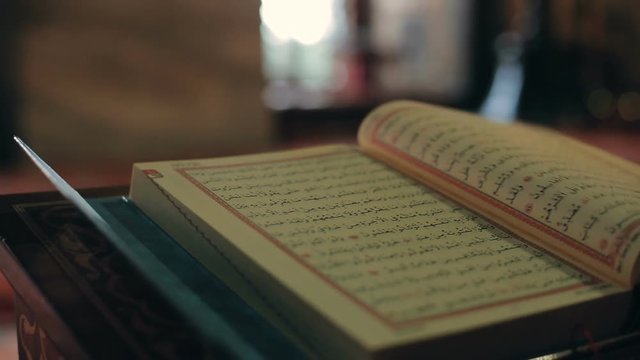 turning pages of the Quran in mosque