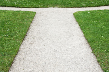 gravel path junction. fork in the road. decision concept with copy space.