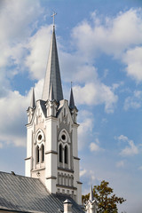Fototapeta premium Towers and crosses on roof of Lutheran Church of St. John monument of 18th century architecture neo-Gothic style in European city Grodno