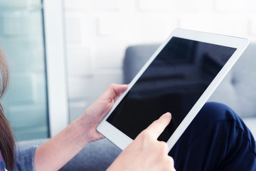 Closeup people using tablet with blank screen in office. Business and technology concept.