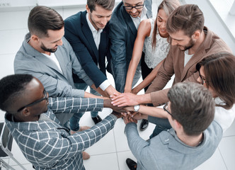 Fototapeta premium close up.multinational business team folded their hands together