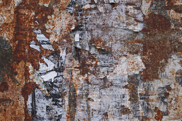 Fototapeta premium rusty metal grunge background with peeling poster scraps 