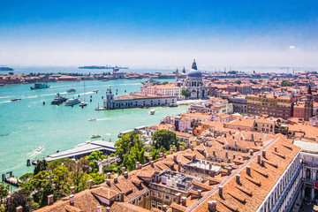 Panoramic view of Venice - Basilica Santa Maria della Salute, Grand Canal with gondolas and red tiled roofs of houses, Venice, Italy