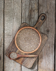 Chia seeds for healthy eating. In a wooden bowl on a wooden table. Rustic style
