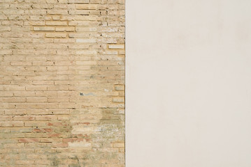 Background of a wall half white and half with bricks, divided into two halves.