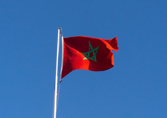 Real flag of morocco on blue sky background