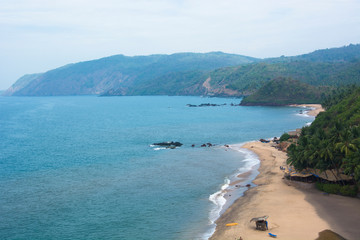 A cliff top view of Cola Beach in Goa, India on a bright sunny day