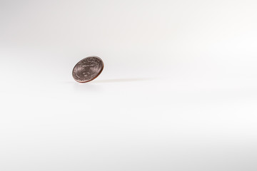 Dollar coin rotating on white background, concept of American economy.