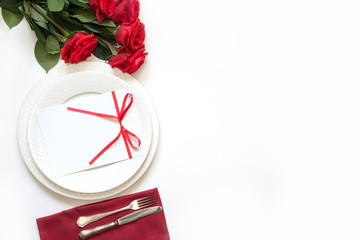 Valentine's day dinner. Romantic table setting with red roses. View from above.