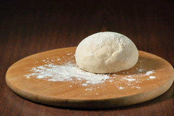 Dough and flour on a wooden platform