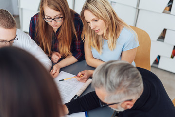 Dedicated business team gathered around a report