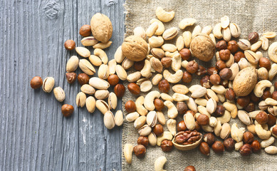 Assortment of nuts on a dark wooden table. View from above