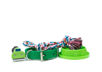 Pet supplies concept. Pet toy, Brush and bowls on isolated white background.