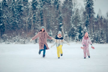 Family of mom and kids vacation on Christmas eve outdoors