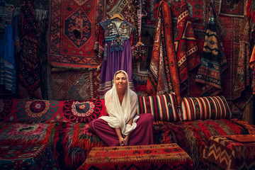 Woman sitting in carpet shop, Cappadocia, Turkey - obrazy, fototapety, plakaty