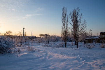 Industrial winter landscape at sunset