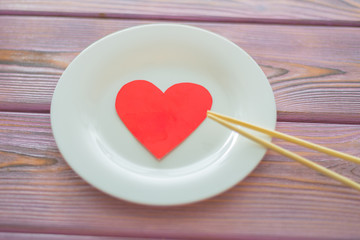 Love heart on a plate. The concept of nutrition love, heartwarming, losing weight because of love.