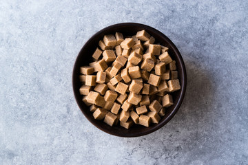 Raw Organic Brown Sugar Cubes in Wooden Bowl Ready to Eat.