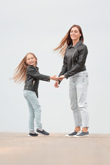 Fototapeta premium rear view. mother and daughter holding each other's hands