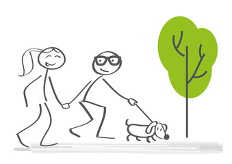 Paar mit Hund geht spazieren