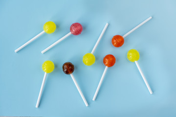 Lollipops on a blue background. Top view.