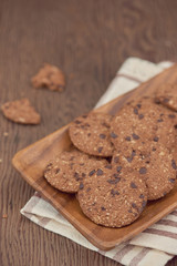 Homemade chocolate cookies on white plate, selective focus