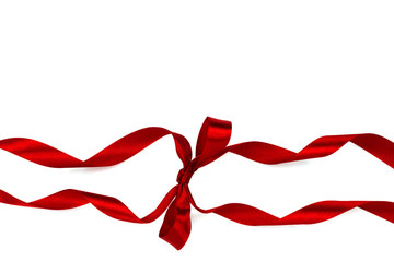 Beautiful decorative shiny red silk ribbon with a bow on isolated white background. Cut out.