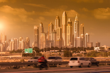 Street of Dubai with skyline arabian view of a crossroad with cars and palaces in the background,...