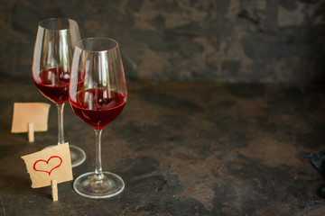 red wine, transparent glass (beverage and a note with a heart). top