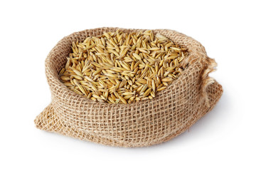 Oat seeds (Avena sativa) also known as the common oat in burlap sack isolated on white background