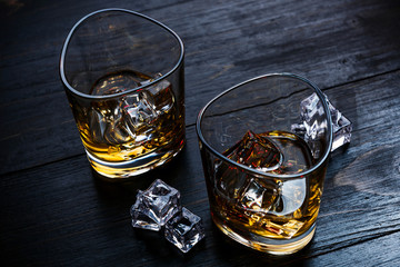whiskey with ice in modern glasses