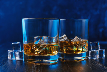 whiskey with ice in modern glasses