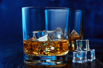 whiskey with ice in modern glasses