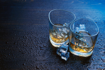 whiskey with ice in modern glasses