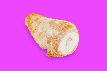 Single baked roll with cream in center on violet background