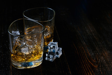 whiskey with ice in modern glasses