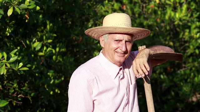 Senior man in the field smiling looking at camera