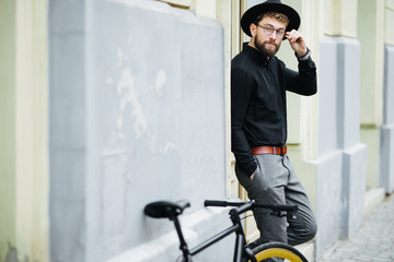 People, style, leisure and lifestyle - young hipster man with fixed gear bike on city street