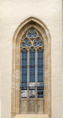 Fototapeta na wymiar Old door on the façade of stone building