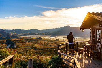 Phayao, Thailand - January 3, 2019: Tourist visit on a view of the mountains when sunrise at the coffee shop, which gives a romantic feeling in love at the Phu Lanka Viewpoint.