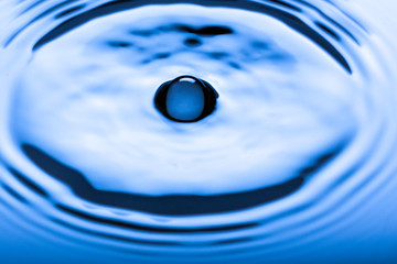Blue water droplets on a shiny surface