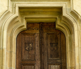 Old door on the façade of stone building