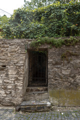 Fototapeta na wymiar Old door on the façade of stone building