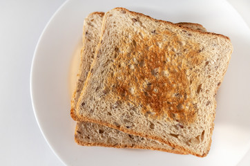 Toasted rye bread on a white plate, healthy food